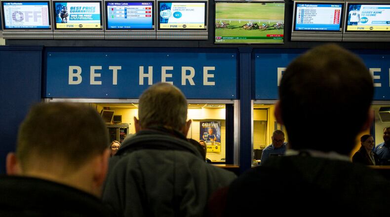 ESHER, ENGLAND - FEBRUARY 04: Racegoers in the betting shop area at Sandown Park on February 4, 2017 in Esher, England. (Photo by Alan Crowhurst/Getty Images)
