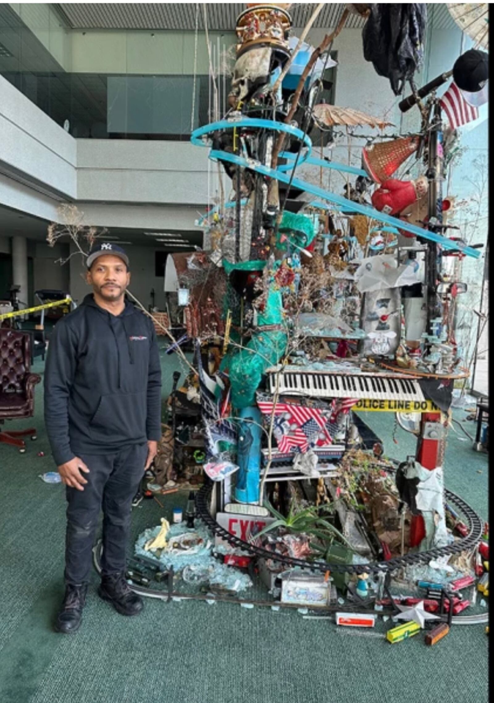 Robert Blackstone stands next to his art installation called "Crystal City," which he started decades ago on his grandmother's dining table. Blackstone was shot and killed on South Main Street in Dayton on Aug. 1, which was the first murder in downtown since the Oregon District mass shooting in August 2019. CONTRIBUTED