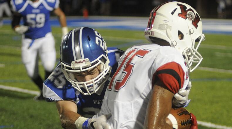 Wayne’s Ray James (with ball) is taken down by Miamisburg’s Austin Turner. Wayne defeated host Miamisburg 45-12 in a Week 4 high school football game in what also was the debut of Holland Field on Friday, Sept. 16, 2016. MARC PENDLETON / STAFF