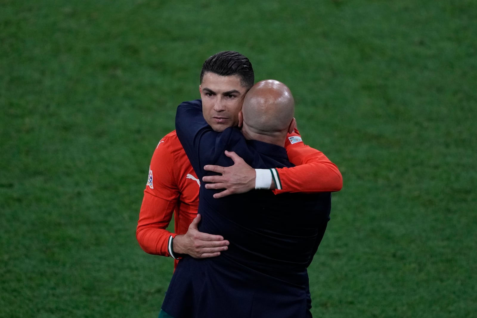 Portugal's Cristiano Ronaldo, left, embraces to Portugal coach Roberto Martinez during the Nations League final soccer match between Portugal and Spain at the Allianz Arena in Munich, Germany, Sunday, June 8, 2025. (AP Photo/Michael Probst)