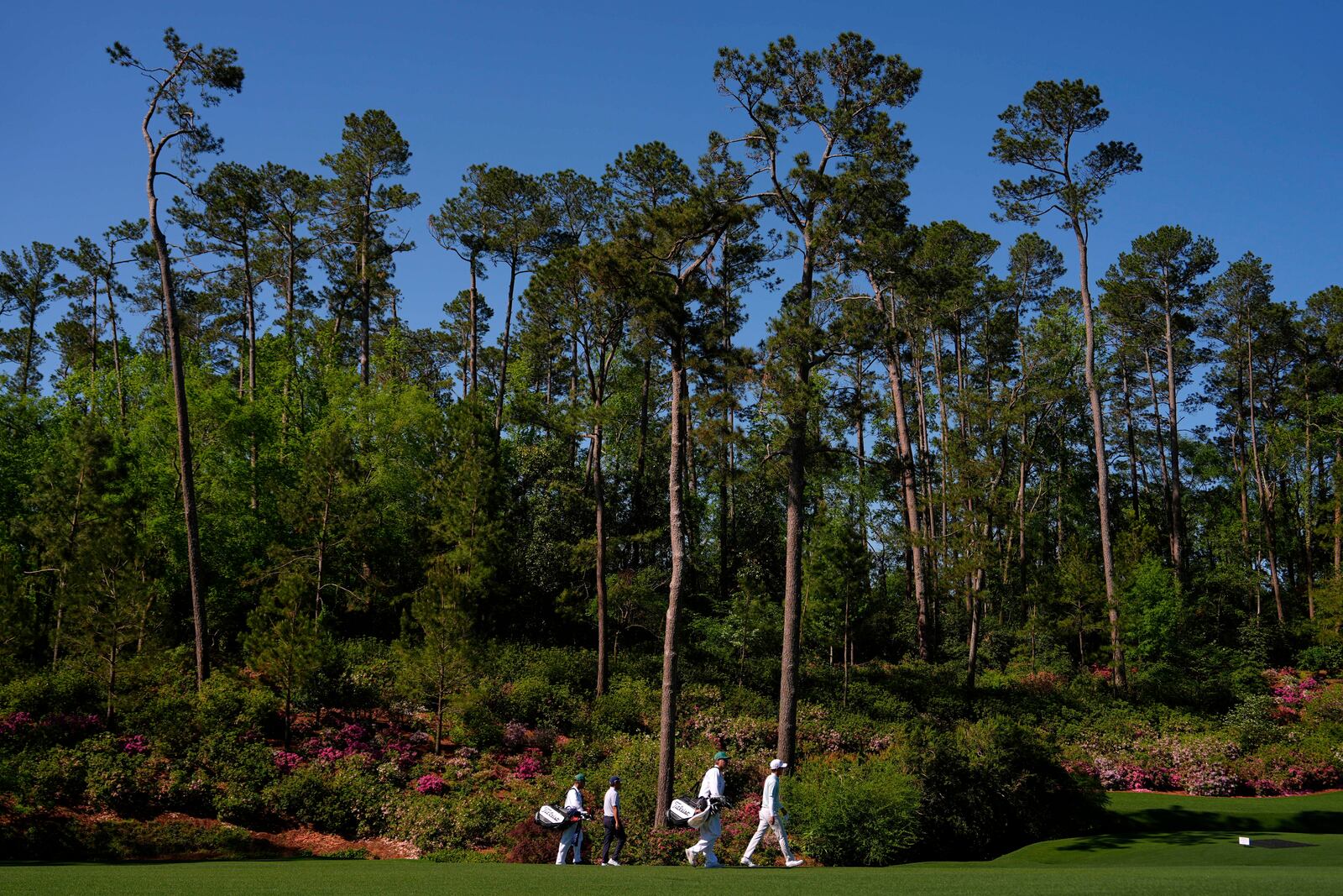 Michael Kim, right, and Byeong Hun An, of South Korea, walks along the 13th fairway during a practice round at the Masters golf tournament, Tuesday, April 8, 2025, in Augusta, Ga. (AP Photo/Julia Demaree Nikhinson)