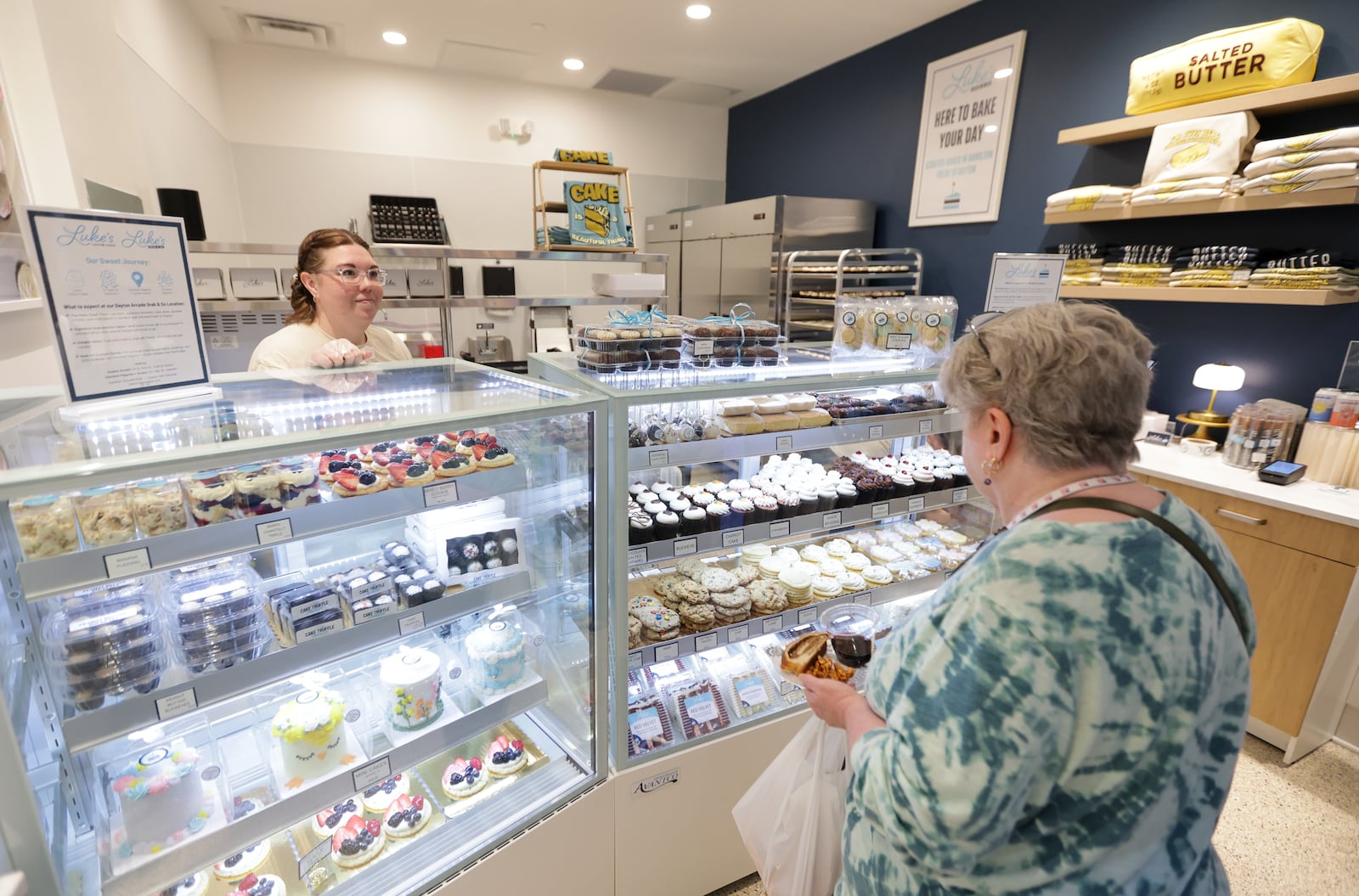 A customer looks at Luke's Custom Cakes' Grab and Go on Thursday, March 6 at Dayton Arcade. The Dayton Arcade celebrated the opening of the north section on Friday, March 6 with a Friends and Family Retail Reveal event. BRYANT BILLING / STAFF