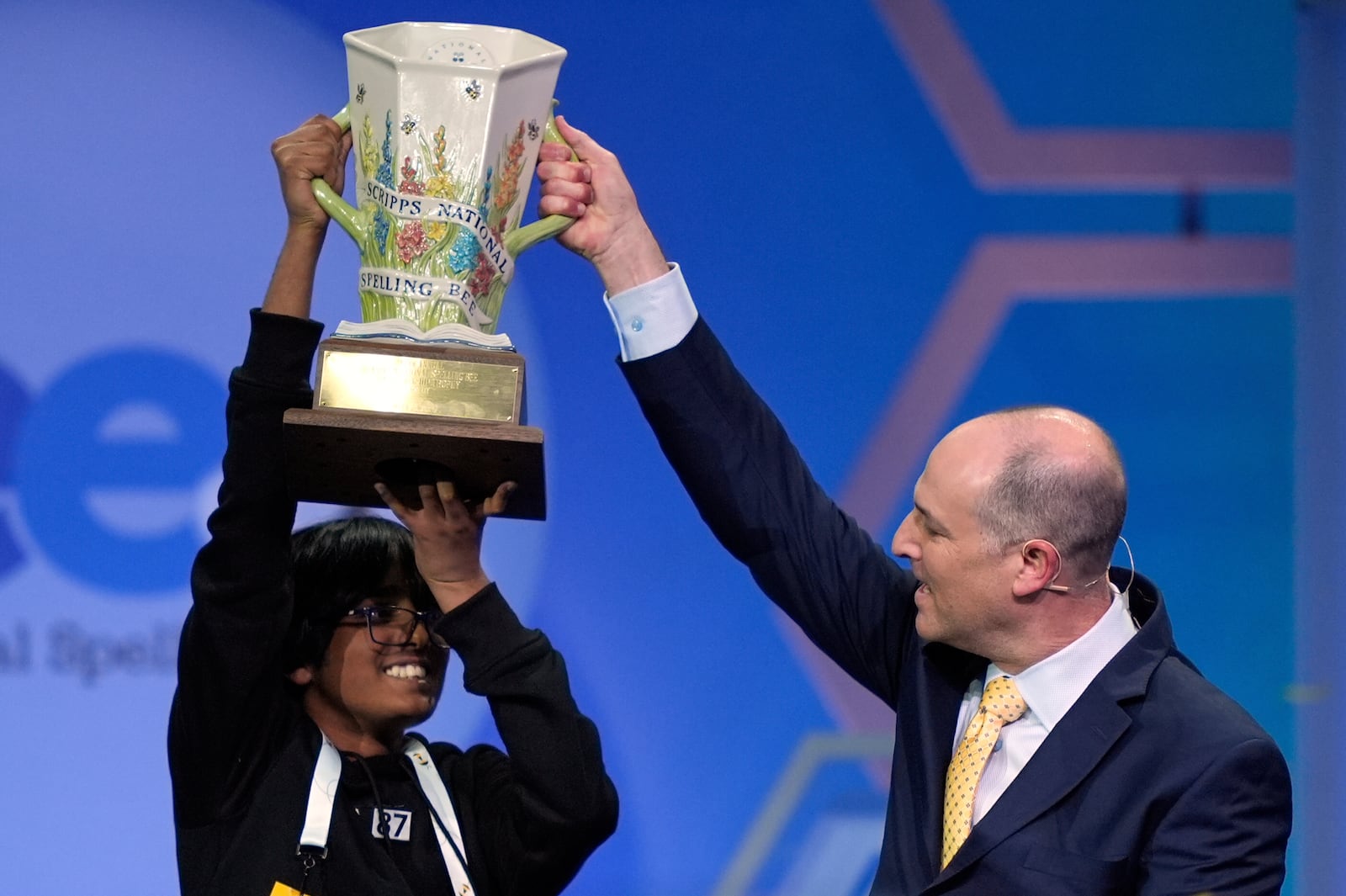 E.W. Scripps Company president and CEO Adam Symson presents the trophy to Faizan Zaki, 13, of Dallas, the winner of the 2025 Scripps National Spelling Bee, Thursday, May 29, 2025, in Oxon Hill, Md. (AP Photo/Julia Demaree Nikhinson)