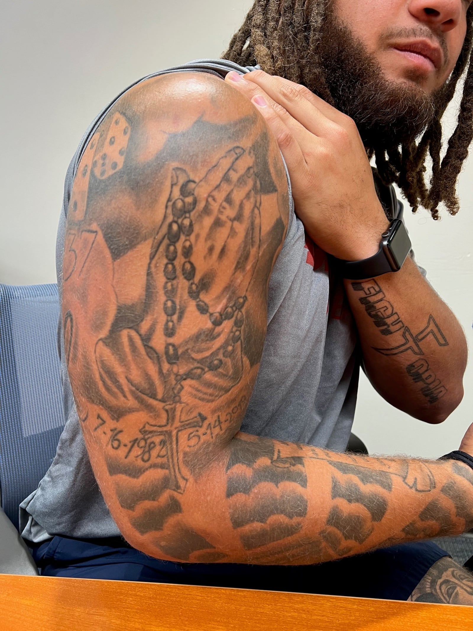 Jerell Lewis shows off the folded hands and rosary beads tattoo honoring his late mother, Elizabeth Lewis. Her birth and death dates are at the bottom of the piece. All of his tattoos have been done by Endless Ink Tattooing in Piqua. His MMA coach Johny Conner is also his tattoo artist. Tom Archdeacon/CONTRIBUTED