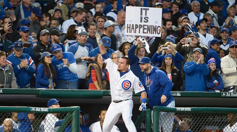 CHICAGO, IL - OCTOBER 13: Kyle Schwarber #12 of the Chicago Cubs celebrates at the dugout after hitting a solo home run in the seventh inning against the St. Louis Cardinals during game four of the National League Division Series at Wrigley Field on October 13, 2015 in Chicago, Illinois. (Photo by David Banks/Getty Images)