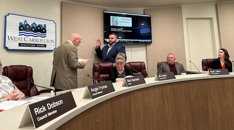 West Carrollton Mayor Rick Barnhart (left) administers the oath of office to Michael Boyle (right) during a West Carrollton City Council meeting Tuesday, Feb. 13, 2024. Boyle fills a seat vacated by Barnhart, who was elected mayor in November. CONTRIBUTED