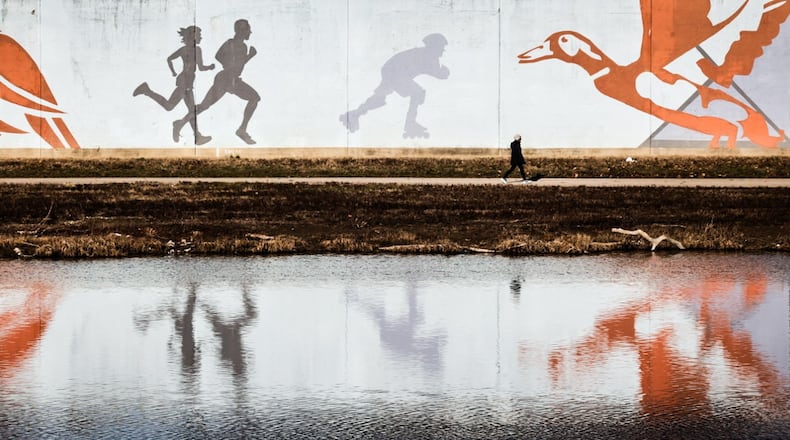 FILE PHOTO: A lone walker hikes along the Great Miami River Wednesday afternoon Dec. 27, 2023. JIM NOELKER/STAFF