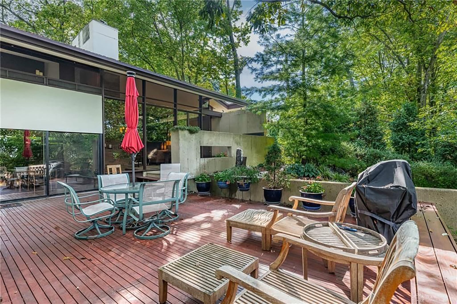 The two level deck on the back of the house has stone walls and surrounding it and overlooks the wooded lot. CONTRIBUTED