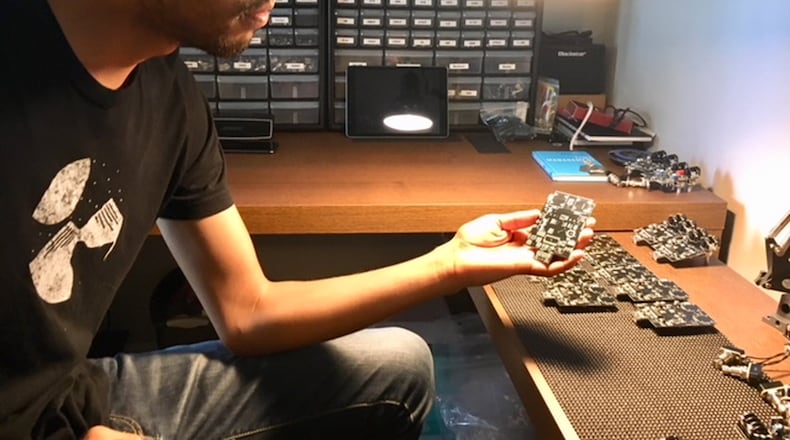 Mike Trombley, owner of Red House Electronics in Troy, shows the circuits of some of his guitar effects pedals in progress. THOMAS GNAU/STAFF