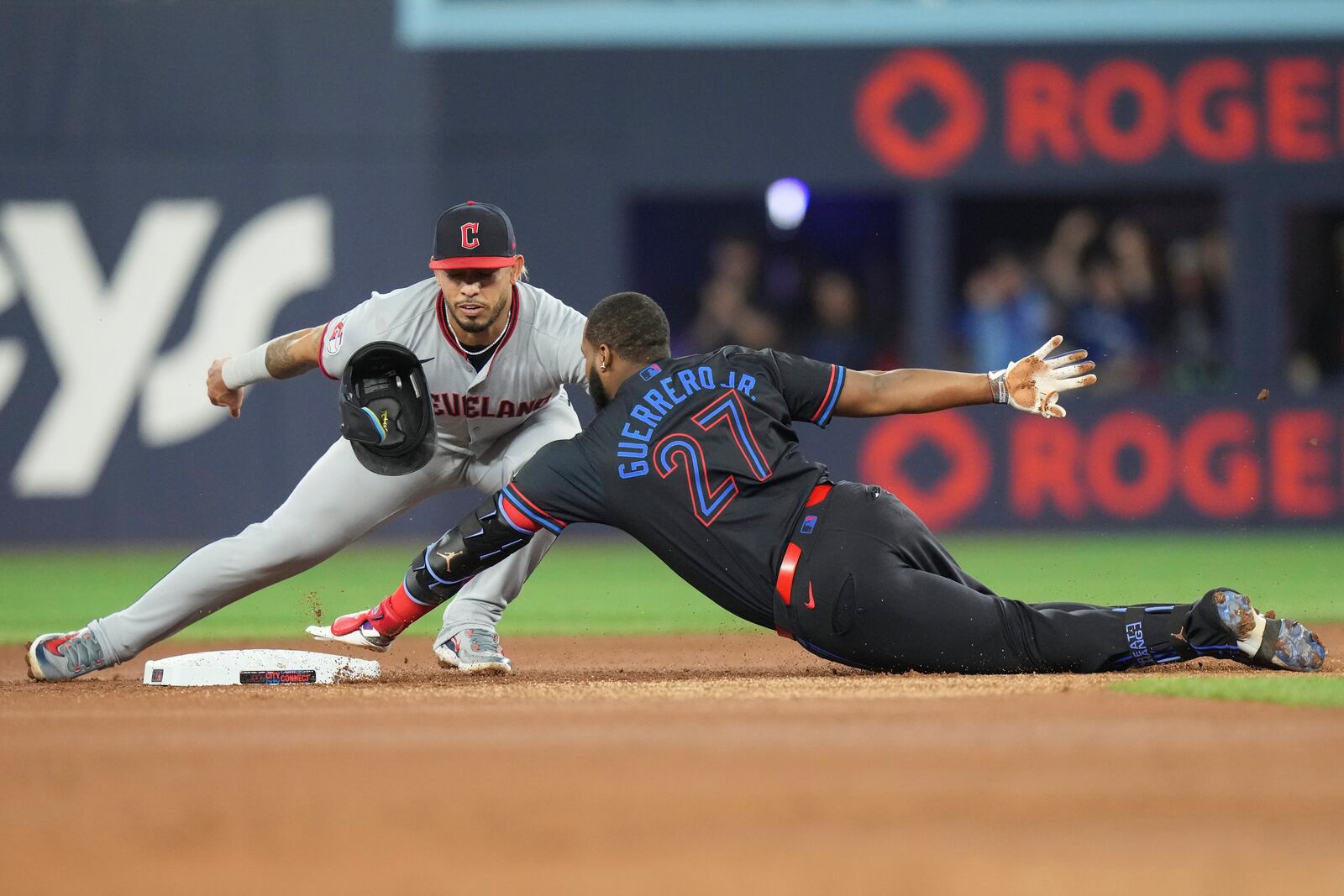 Toronto Blue Jays' Vladimir Guerrero Jr. is tagged out at second base by Cleveland Guardians second baseman Gabriel Arias during the first inning of a baseball game in Toronto on Friday, May 2, 2025. (Chris Young/The Canadian Press via AP)