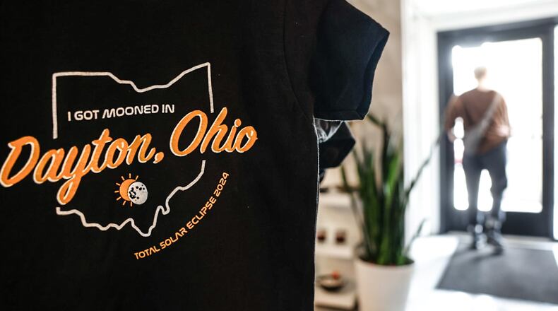 This Dayton solar eclipse shirt is sold at Heart Mercantile on East 5th Street in the Oregon District. JIM NOELKER/STAFF
