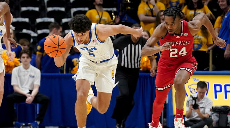 Pittsburgh forward Nate Santos (5) steals the ball next to Louisville forward Jae'Lyn Withers (24) during the second half of an NCAA college basketball game in Pittsburgh, Tuesday, Feb. 7, 2023. Pittsburgh won 91-57. (AP Photo/Matt Freed)