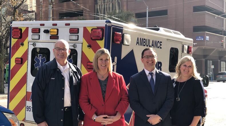 Dayton fire Chief Jeff Payne, Mayor Nan Whaley, American Medical Response regional director John Robben and Beth Calcidise, director of CareFlight and transportation with Miami Valley Hospital. CORNELIUS FROLIK / STAFF
