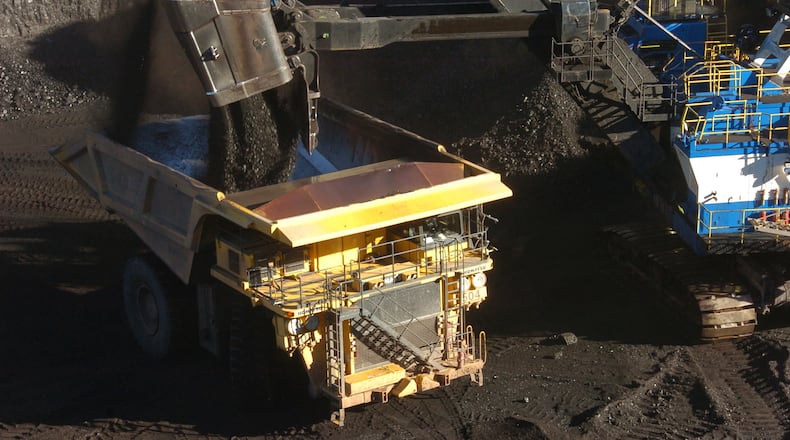 FILE - A mechanized shovel loads coal into a haul truck at a mine near Decker, Mont., on Nov. 15, 2016. (AP Photo/Matthew Brown, File)