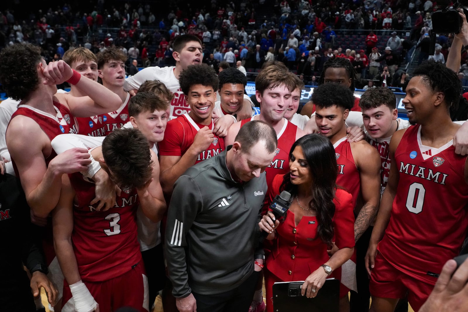 Miami (Ohio) head coach Travis Steele, center, is interviewed following a First Four college basketball game against SMU in the NCAA Tournament in Dayton, Ohio, Wednesday, March 18, 2026. (AP Photo/Jeff Dean)
