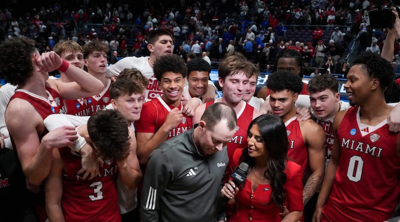 Miami (Ohio) head coach Travis Steele, center, is interviewed following a First Four college basketball game against SMU in the NCAA Tournament in Dayton, Ohio, Wednesday, March 18, 2026. (AP Photo/Jeff Dean)
