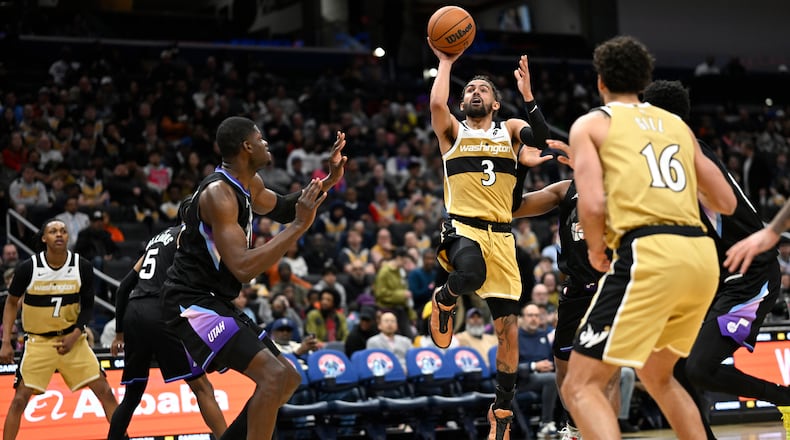 Washington Wizards guard Trae Young (3) goes to shoot during the second half of an NBA basketball game against the Utah Jazz, Thursday March 5, 2026, in Washington. (AP Photo/John McDonnell)