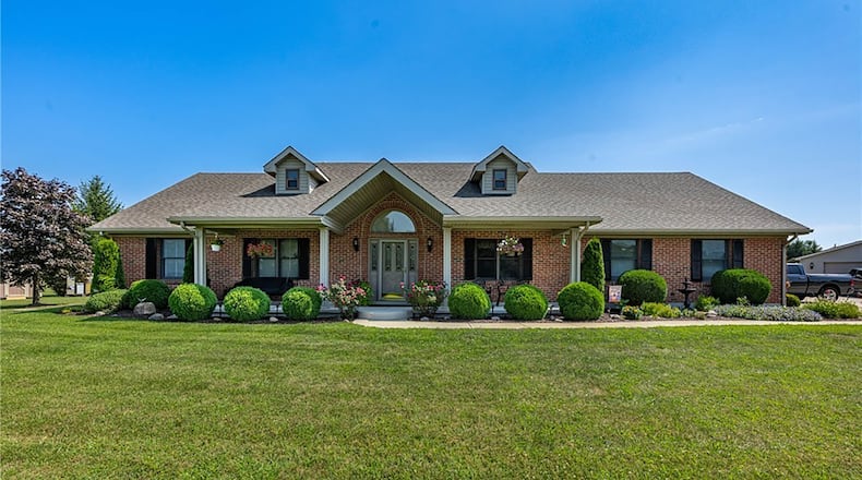 This brick story and a half sits on 2.55 acres in New Carlisle. It has four bedrooms and three bathrooms and has a two car attached and two car detached garage and three additional yard buildings. CONTRIBUTED