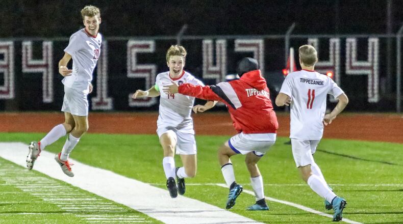 Members of the Tippecanoe High School boys soccer team celebrate after beating Columbus Academy 1-0 in a Division II state semifinal match on Wednesday night at London High School’s Bowlus Field. CONTRIBUTED PHOTO BY MICHAEL COOPER