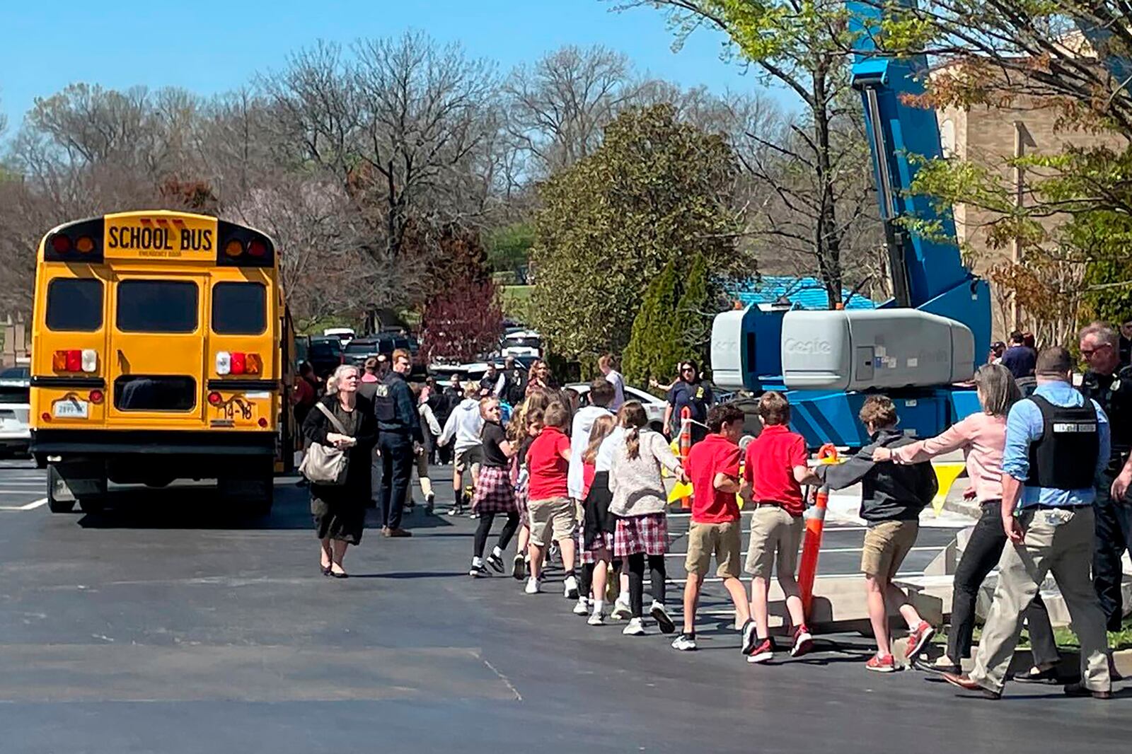 FILE - Children from The Covenant School, a private Christian school in Nashville, Tenn., hold hands as they are taken to a reunification site at the Woodmont Baptist Church after a deadly shooting at their school on Monday, March 27, 2023. (AP Photo/Jonathan Mattise, File)