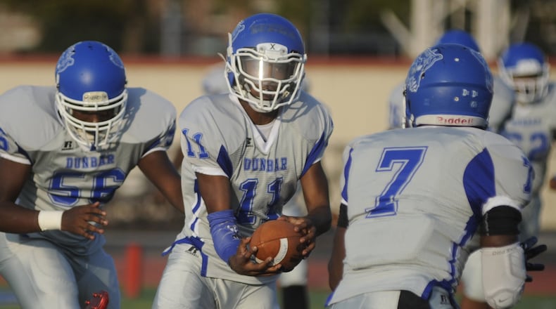 In this file photo from 2018, Dunbar High School quarterback Jamar Walker has the ball. MARC PENDLETON / STAFF