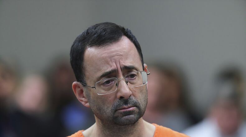 In this Nov. 22, 2017, file photo, Dr. Larry Nassar, 54, appears in court for a plea hearing in Lansing, Mich. Nassar was sentenced to decades in prison for sexually assaulting young athletes for years under the guise of medical treatment. (AP Photo/Paul Sancya, File)