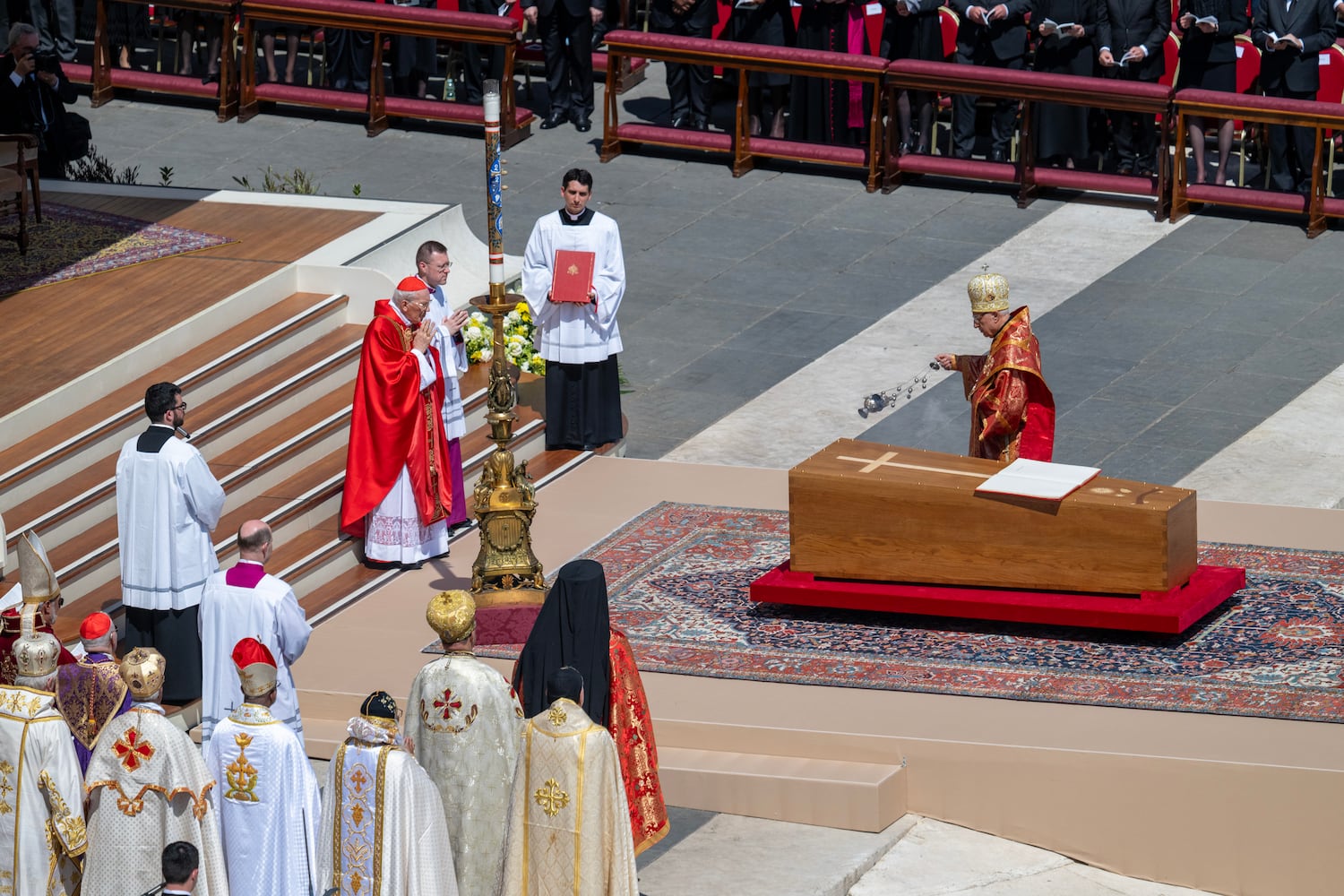 An eastern church leader blesses the coffin of Pope Francis with incense during his funeral service, at the Vatican on Saturday, April 26, 2025. (James Hill/The New York Times). 
