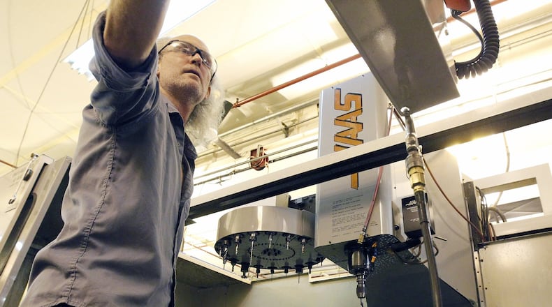 Machinist James Mitchner sets up a CNC machine at Starwin Industries entrance in Kettering, in this 2017 file photo. The small manufacturing company conducts half of its business as a defense manufacturer according to company president Rick Little.