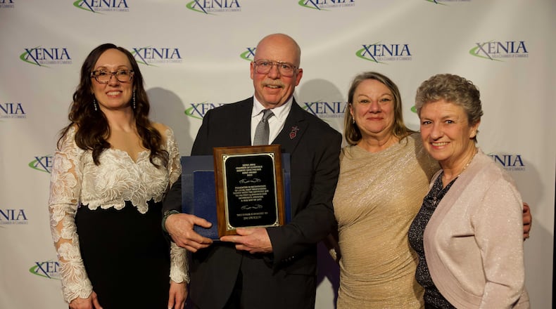 Tim Spradlin (center) was one of several individuals and businesses honored by the Xenia Chamber of Commerce last week for service to the community. CONTRIBUTED