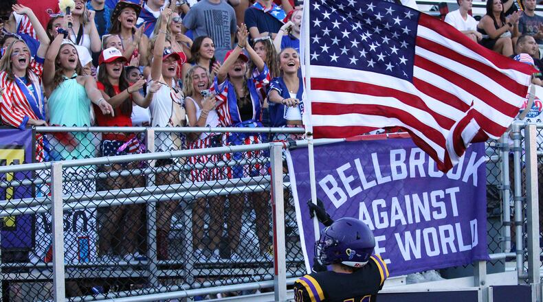 On USA night, Bellbrook’s Preston Valentie waves the American flag in front of the student section before the Golden Eagles game against Alter. (Sept. 20)