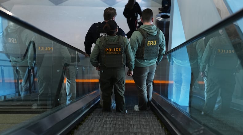 Federal law enforcement officers move through Philadelphia International Airport, Tuesday, March 24, 2026, in Philadelphia. (AP Photo/Matt Rourke)