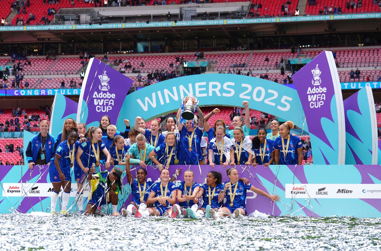Chelsea's Millie Bright lifts the English Women's FA Cup trophy as she and teammates celebrate winning the final soccer match against Manchester United, at Wembley Stadium, in London, Sunday, May 18, 2025. (John Walton/PA via AP)