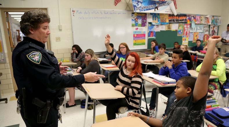 Kettering Police school resource officer Carla Sucher talks with seventh grade students in a health class at Van Buren Middle School about alcohol abuse. LISA POWELL / STAFF