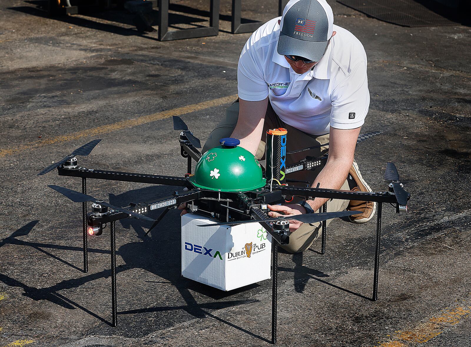 Brayton Talkington, AVP of flight operations at DEXA, prepares a drone to carry lunch from the Dublin Pub in Dayton to Mayor Jeffrey J. Mims Jr. on Thursday, March 13. MARSHALL GORBY\STAFF