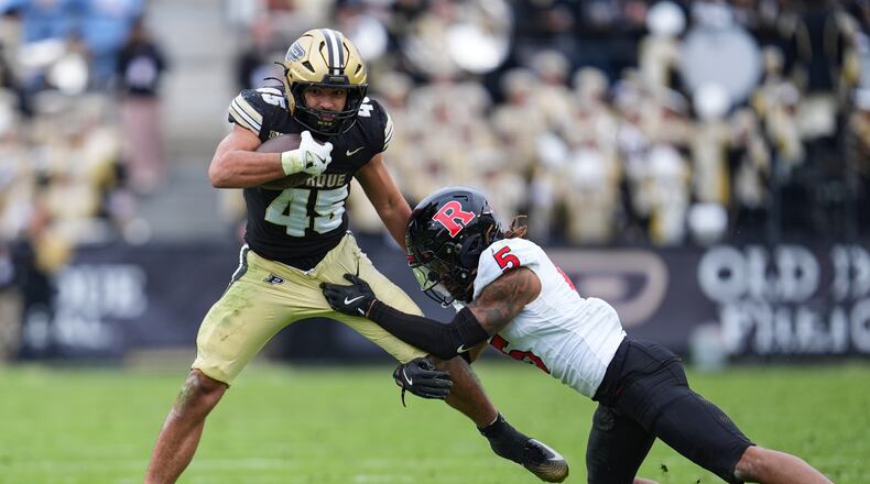 Rutgers defensive back Kaj Sanders (5) tackles Purdue running back Devin Mockobee (45) during the second half of an NCAA college football game in West Lafayette, Ind., Saturday, Oct. 25, 2025. (AP Photo/Michael Conroy)