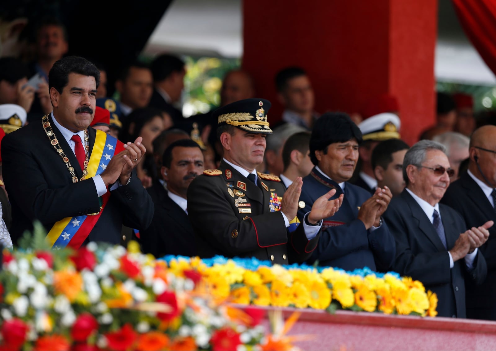 FILE - Venezuela's President Nicolas Maduro, from left, Operational Strategic Commander Gen. Vladimir Padrino Lopez, Bolivia's President Evo Morales and Cuba's President Raul Castro applaud during a military parade commemorating the one year anniversary of the death of Venezuela's former President Hugo Chavez in Caracas, Venezuela, March 5, 2014. (AP Photo/Fernando Llano, File)