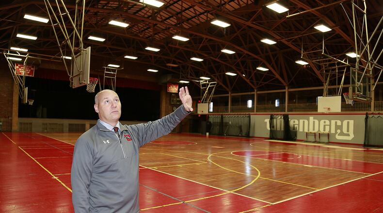 Wittenberg University Athletic Director Gary Williams talks about some of the improvements that will be made in the school’s Field House. Wittenberg was awarded $4.5 million in Ohio Historic Preservation Tax Credits to aid in the restoration of the historic field house built in 1929 and the construction of the Health, Wellness & Athletics Complex. Bill Lackey/Staff Wittenberg University Athletic Director Gary Williams looks over the bronze plaque on the school’s field house commemorating its construction in 1929. Wittenberg was awarded $4.5 million in Ohio Historic Preservation Tax Credits to aid in the restoration of the historic field house built in 1929 and the construction of the Health, Wellness & Athletics Complex. Bill Lackey/Staff
