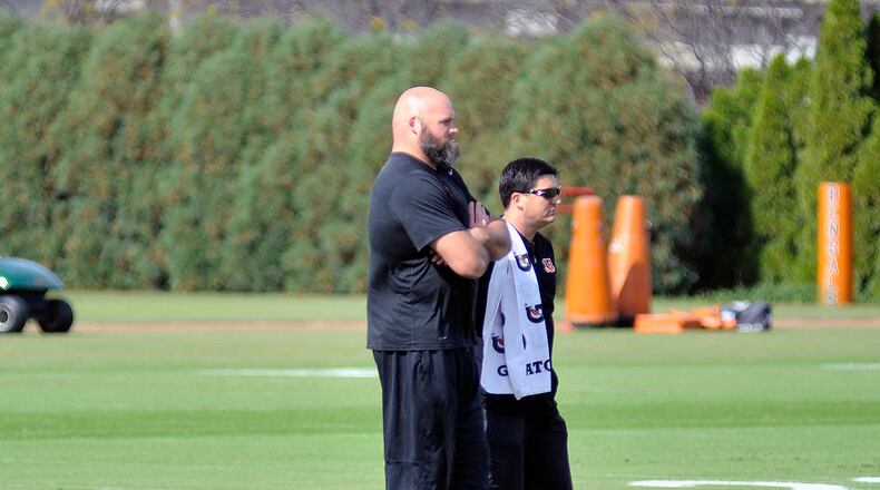 Cincinnati Bengals left tackle Andrew Withworth watches practice Wednesday along side director of rehabilitation Nick Cosgray. JAY MORRISON/STAFF