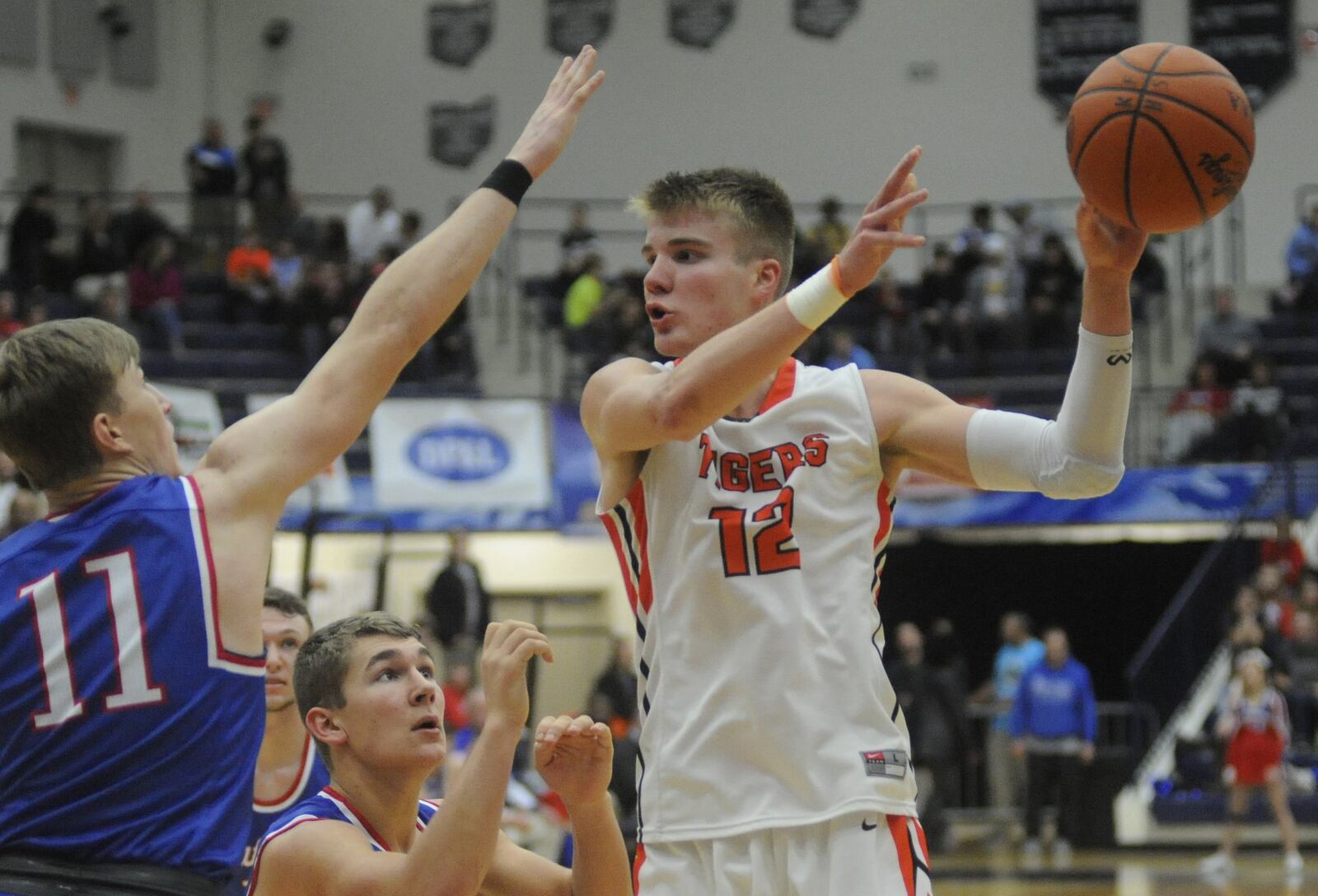 Versailles junior and OSU commit Justin Ahrens (with ball) tallied 26 points and nine rebounds in a 61-56 defeat of Tri-Village in the Premier Health Flyin’ to the Hoop at Trent Arena in Kettering last season. MARC PENDLETON / STAFF