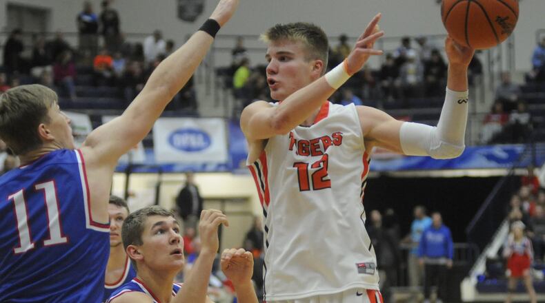 Versailles junior and OSU commit Justin Ahrens (with ball) tallied 26 points and nine rebounds in a 61-56 defeat of Tri-Village in the Premier Health Flyin’ to the Hoop at Trent Arena in Kettering last season. MARC PENDLETON / STAFF