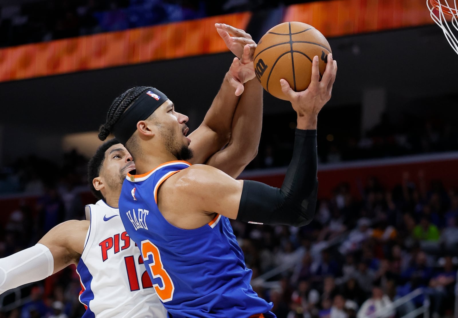 Detroit Pistons forward Tobias Harris, left, defends New York Knicks guard Josh Hart (3) who goes to the basket during the first half of Game 4 of an NBA basketball first-round playoff series Sunday, April 27, 2025, in Detroit. (AP Photo/Duane Burleson)