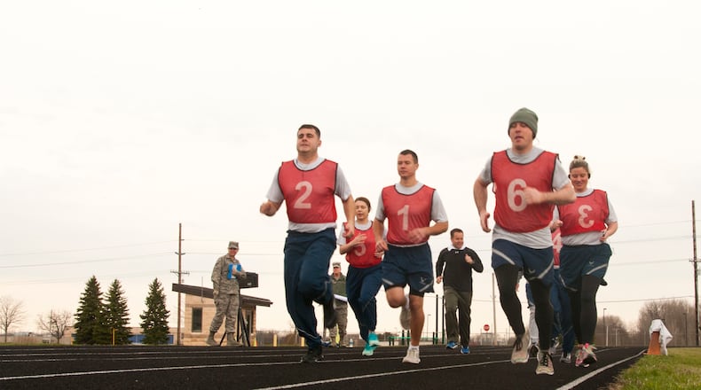 U.S. Air National Guard Airmen from the 121st Air Refueling Wing, participate in the run portion of the physical fitness test April 6, 2018, on the track at Rickenbacker Air National Guard Base, Ohio. Air Force officials announced May 22 all official fitness testing is suspended until Oct. 1. (U.S. Air Force photo/Airman 1st Class Tiffany Emery)