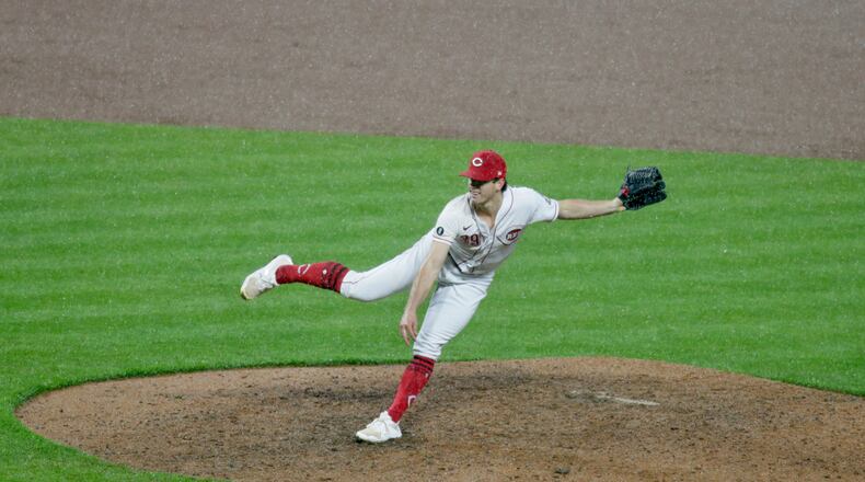 Reds reliever Lucas Sims walks in the go-ahead run against the Diamondbacks in the eighth inning in the rain on Tuesday, April 20, 2021, at Great American Ball Park in Cincinnati. David Jablonski/Staff