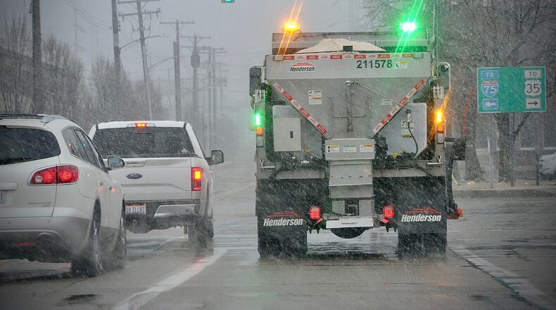 Salt trucks were out working in downtown Dayton Friday, March 11, 2022, as snow started to fall. MARSHALL GORBY \STAFF