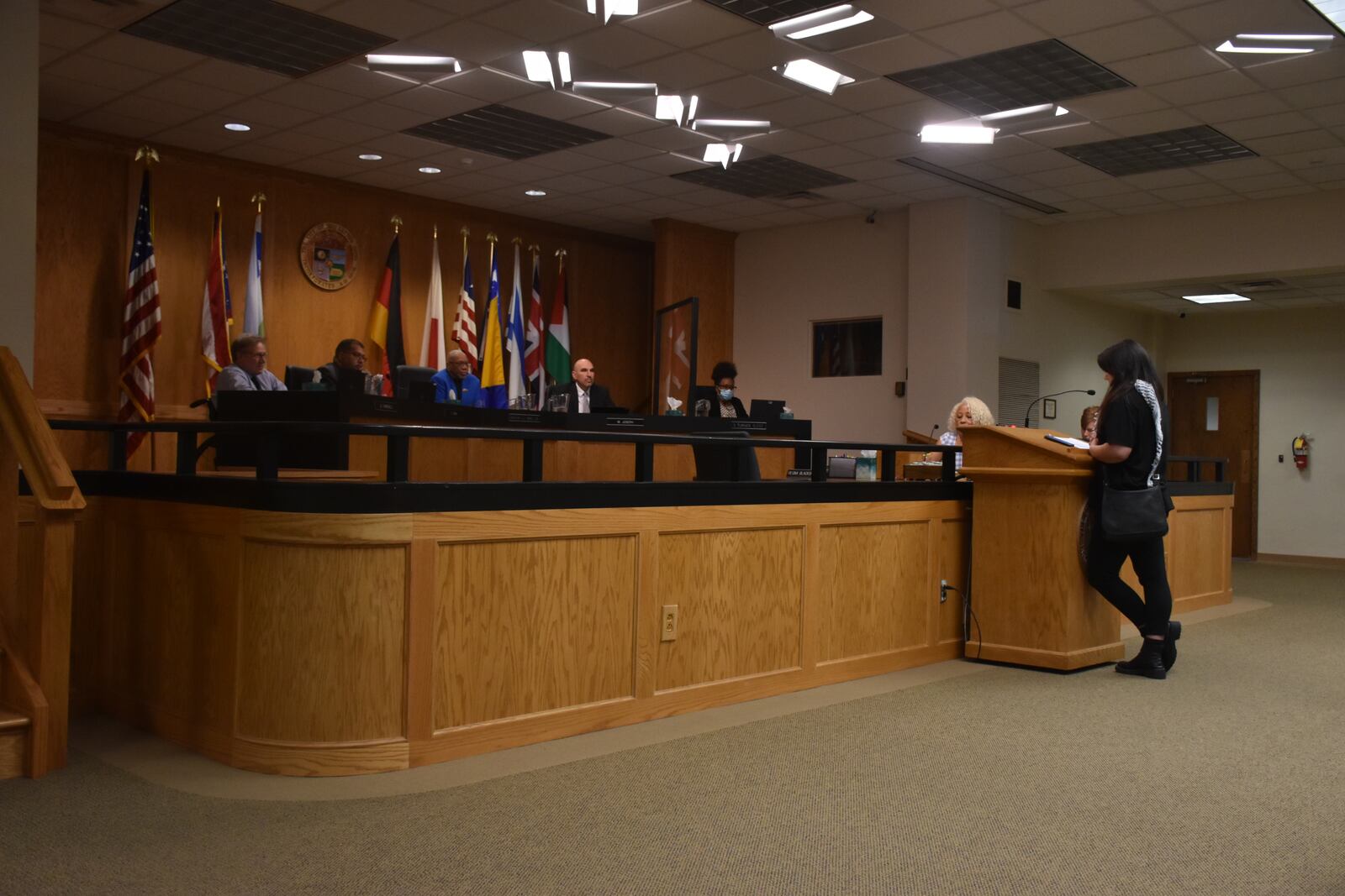 Samantha Stacy, a local activist and supporter of the Party for Socialism and Liberation, speaks at a Dayton City Commission meeting to criticize the city's food distribution law. CORNELIUS FROLIK / STAFF