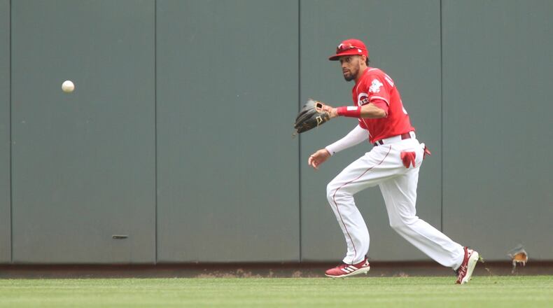 Reds center fielder Billy Hamilton fields a ball against the Cardinals on Sunday, June 10, 2018, at Great American Ball Park in Cincinnati. David Jablonski/Staf