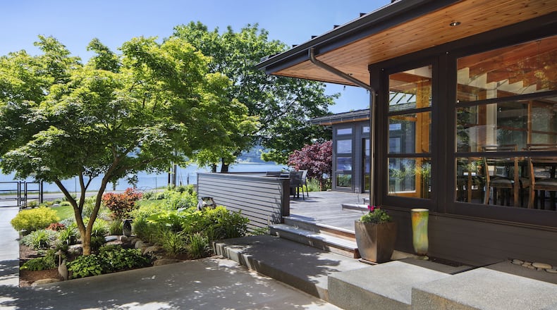 Bob and Mary Carlson s Bainbridge Island home originally was a 1930s-era cabin. Architect Tom Kundig remodeled it in the early 1980s, and now architect Tom Kuniholm has done a major remodel that expands and updates many of those aesthetic cues, he says. Bob Grimm was the builder for the remodel (Bob Carlson did a lot of hands-on work himself, and Mary Carlson handled interior design). (Steve Ringman/The Seattle Times/TNS)