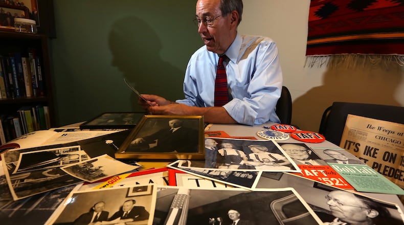 Former Ohio Gov. Bob Taft looks through photographs and memorobilia relating to his grandfather the late Sen. Robert A. Taft who tried three times to become the Republican nominee for president. LISA POWELL / STAFF