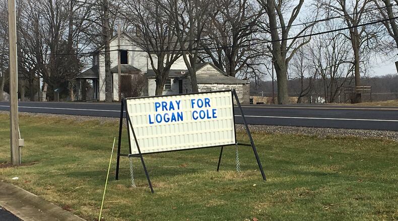 A sign outside Quest Community Church asks Champaign and Logan County residents to pray for the victim on Friday’s shooting.