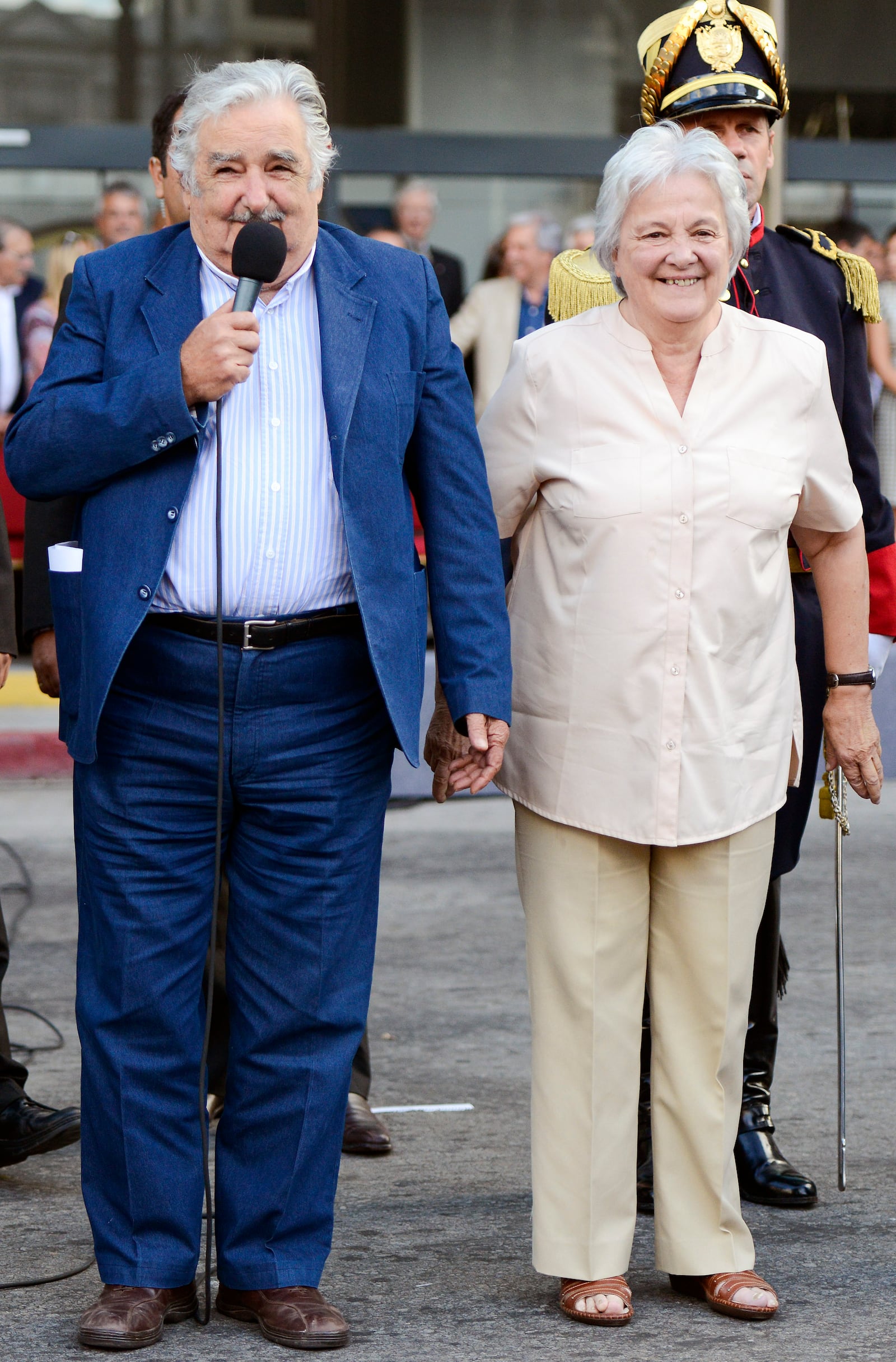 FILE - Uruguay's President Jose Mujica, left, and his wife Lucia Topolansky attend a flag ceremony in Montevideo, Uruguay, Feb. 27, 2015. (AP Photo/Matilde Campodonico, File)